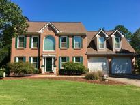Charming brick two-story home with a well-manicured lawn and a two-car garage at 323 Dewpoint Ct # 35, Marietta, GA 30064