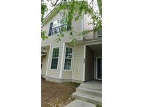 Two story home showcasing a beige exterior with black shutters and a small front lawn at 162 Odyssey Turn, Conyers, GA 30012