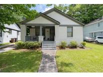 Charming brick home with a well-manicured lawn and inviting front porch at 2284 Dauphine St, East Point, GA 30344