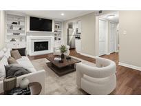 Bright living room features fireplace, built-in bookshelves, and modern furnishings at 95 Ivy Ne Trl, Atlanta, GA 30342