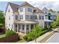 Charming two-story home with a covered front porch and manicured landscaping at 1085 Celebration Dr, Roswell, GA 30076