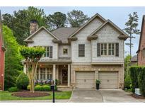 Charming two-story home with brick and shake siding, attached two-car garage, and well-manicured lawn at 4674 Lakeway Pl, Alpharetta, GA 30005