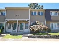 Charming townhome featuring a well-maintained front yard and neutral-toned exterior at 1812 Ashborough Se Cir # C, Marietta, GA 30067