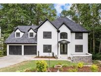 Charming two-story home with a well-manicured lawn and two-car garage at 4978 Thornwood Nw Cv, Acworth, GA 30102