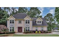 Charming two-story home with landscaped yard and inviting curb appeal on a treed lot at 509 Orchards Walk, Stone Mountain, GA 30087