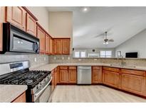Well-equipped kitchen features stainless steel appliances, gas range, and ample countertop space at 609 Grand Ashbury Ln, Buford, GA 30518