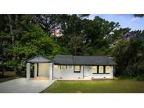 Charming white brick home with a convenient carport and well-manicured lawn at 2223 Columbia Dr, Decatur, GA 30032