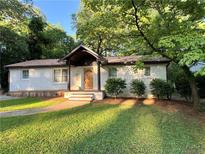 Charming brick home with well-maintained landscaping and a welcoming front porch and wooden door at 3133 Rebecca St, Covington, GA 30014