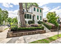 Charming two-story home featuring manicured landscaping and a welcoming entrance with black trim windows at 797 Greenwood Ne Ave, Atlanta, GA 30306