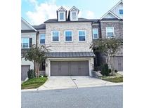 Charming townhome featuring a two-car garage and attractive architectural details at 2128 Sonoma Se Dr, Smyrna, GA 30080