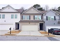 Charming townhome with a two-car garage and neutral-colored siding at 3401 Endurance Ct # 10, Atlanta, GA 30349
