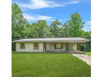 A charming single-story home with a covered porch and a well-maintained front yard at 415 Gray Rd, Carrollton, GA 30116