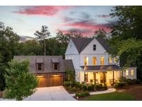 Beautiful two-story modern farmhouse with a welcoming front porch and attached two-car garage at 225 Blueberry Rdg, Milton, GA 30075