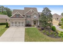 Charming two-story home with manicured lawn and attached two car garage at 44 Kingsford Xing, Acworth, GA 30101