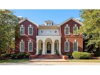 Stately brick home with an elegant entrance featuring a columned portico and manicured landscaping at 1477 Highway 85 Connector, Brooks, GA 30205