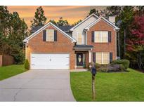 Beautiful two-story brick home with a well-manicured lawn and two car garage at 5885 Raventree Ct, South Fulton, GA 30349