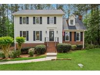 Charming two-story home with brick accents, black shutters, and a well-manicured lawn and front garden at 1275 Mayfield Rd, Milton, GA 30009