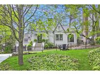 Charming home with a manicured lawn, iron fence and beautiful landscaping at 820 Wilson Nw Rd, Atlanta, GA 30318