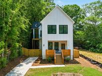 Charming new construction two-story home featuring a modern design, complemented by fresh landscaping and a private, fenced yard at 2438 2Nd Nw St, Atlanta, GA 30318