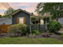 Charming cottage-style home with stone exterior, front porch, and well-manicured landscaping at 403 Blake Se Ave, Atlanta, GA 30316