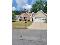 Charming single-Gathering home with a well-maintained lawn and two-car garage in a suburban neighborhood at 1150 Hillary Ln, Lawrenceville, GA 30043
