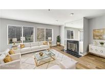 Bright living room with modern decor, fireplace, and large windows allowing ample natural light at 27 Lakes Edge Se Dr, Smyrna, GA 30080