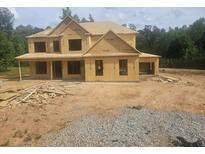 Exterior of new home build showcasing wood frame structure and window placement at 3301 Lions Ruby Ln, Atlanta, GA 30349