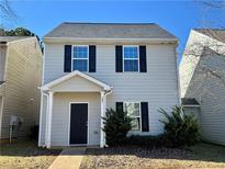 Charming two-story home features a cozy front porch and classic black shutters at 241 Coral Cir, Mcdonough, GA 30253