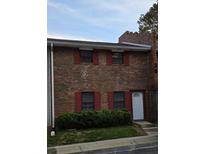 Charming brick townhome featuring red shutters and a well-maintained front yard at 6354 Shannon Pkwy # 20D, Union City, GA 30291