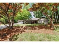 Charming single-story home with mature trees and well-maintained lawn at 5155 Pine Branch Pt, Atlanta, GA 30338