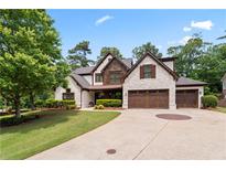 Charming home with stone accents, complemented by a well-manicured lawn and a spacious driveway at 2265 Venture Dr, Marietta, GA 30062
