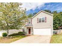 Charming two-story home with a well-manicured lawn, attached garage, and inviting front entry at 314 Meadows Ln, Canton, GA 30114