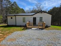 Charming home featuring a wooden porch and a modern metal roof at 4064 Post Rd, Winston, GA 30187