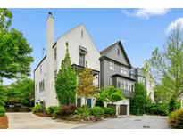 Charming home featuring a mix of white and gray exteriors, surrounded by mature trees and professionally landscaped grounds at 584 Bismark Ne Rd, Atlanta, GA 30324
