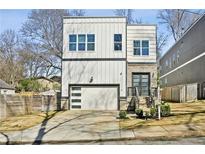 Modern two-story home showcasing a white exterior, garage, and well-maintained front yard at 2020 Bixby Se St, Atlanta, GA 30317
