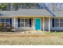 Charming home featuring a vibrant turquoise front door and classic navy shutters at 447 Wallace Way, Rockmart, GA 30153