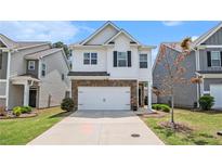 Charming two-story home featuring a two-car garage and a well-maintained front yard at 118 Woodhouse Cir, Acworth, GA 30102