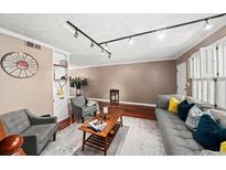 Inviting living room with hardwood floors, track lighting and comfortable seating arrangement at 331 Lakemoore Ne Dr # C, Atlanta, GA 30342
