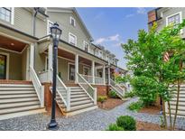 Charming townhomes feature covered porches and landscaped walkways for a welcoming curb appeal at 1076 Green St, Roswell, GA 30075