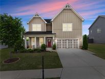 Charming two-story home featuring a covered porch and a well-maintained lawn at 5920 Hart Way, Cumming, GA 30028