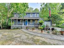 Charming two-story home featuring a welcoming front porch and beautiful landscaping at 1900 Shady Creek Ln, Lawrenceville, GA 30043