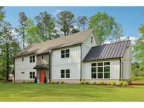Stunning two-story home features a modern farmhouse design, lush green lawn, and inviting curb appeal at 4840 Moon Rd, Powder Springs, GA 30127
