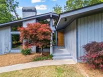 Charming home exterior featuring modern architecture, large windows, and a well-manicured front yard at 5148 Stratham Dr, Dunwoody, GA 30338