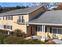 Charming home with a balcony, red door, black shutters, and inviting front entrance with sitting area at 1468 Briarwood Ne Rd # 2003, Atlanta, GA 30319