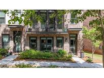 Charming brick townhouse with a cozy balcony and well-maintained landscaping offering curb appeal at 1626 Aldworth Se Pl, Atlanta, GA 30339