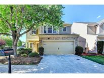 Charming two-story home with stone accents, a two-car garage, and mature trees enhancing curb appeal at 2505 Thackery Ct, Cumming, GA 30041