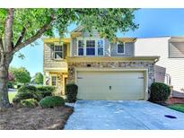 Charming two-story home featuring a stone facade, attached two-car garage, and a well-manicured front yard at 2505 Thackery Ct, Cumming, GA 30041