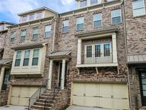 Beautiful brick townhouse with a two-car garage and covered entry at 1263 Linden Ne Ct, Atlanta, GA 30329