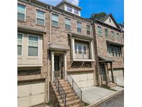 Charming brick townhome features a covered front porch and attached two-car garage at 1263 Linden Ne Ct, Atlanta, GA 30329