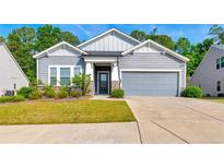 Charming single-Gathering home with manicured lawn, gray siding, and attached two-car garage at 316 Denali Butte Ter, Canton, GA 30114